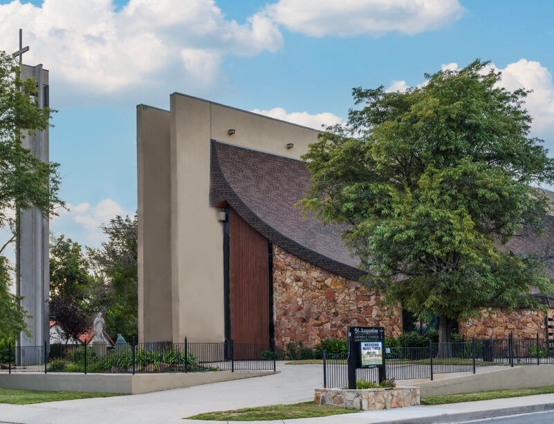 A church building with a tree in front of it