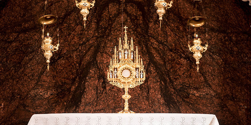 An ornate monstrance sitting on an altar